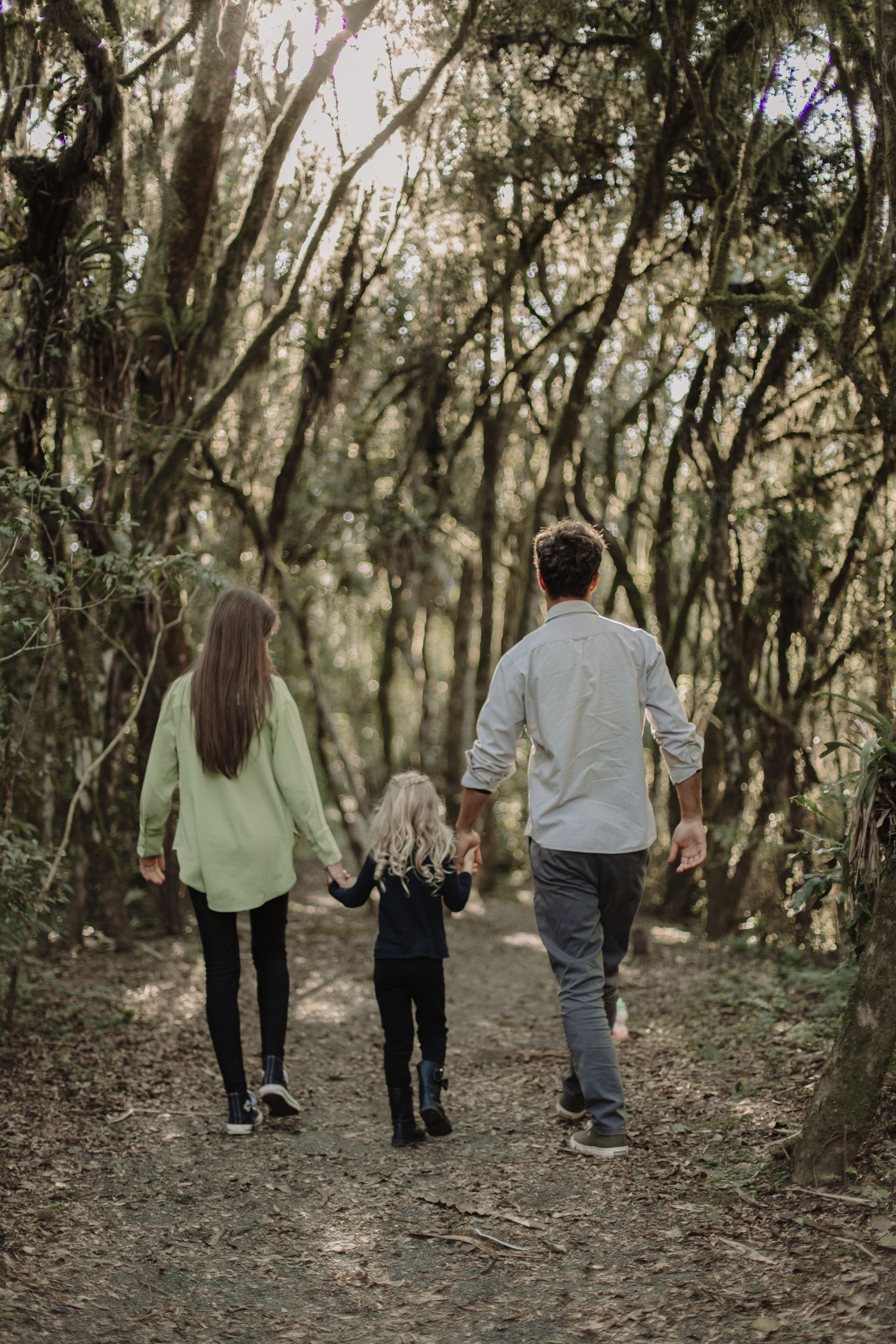 Family walking a wooded path